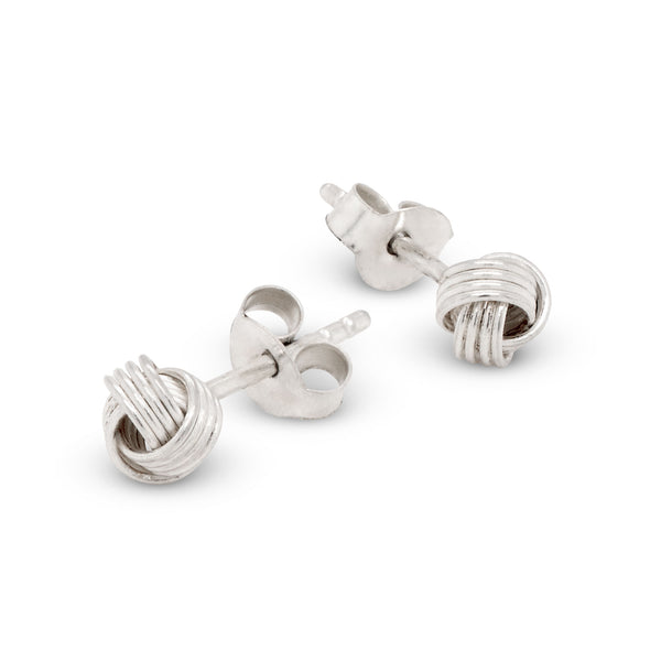 Silver knot-shaped earrings on a white background