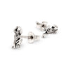 Pair of silver frog earrings on a white background