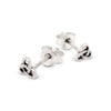 Pair of silver Celtic knot stud earrings on a white background