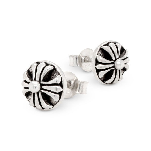 Pair of silver and black floral stud earrings on a white background