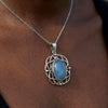 Necklace with a blue pendant on a person's neck