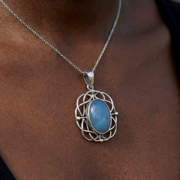 Necklace with a blue pendant on a person's neck