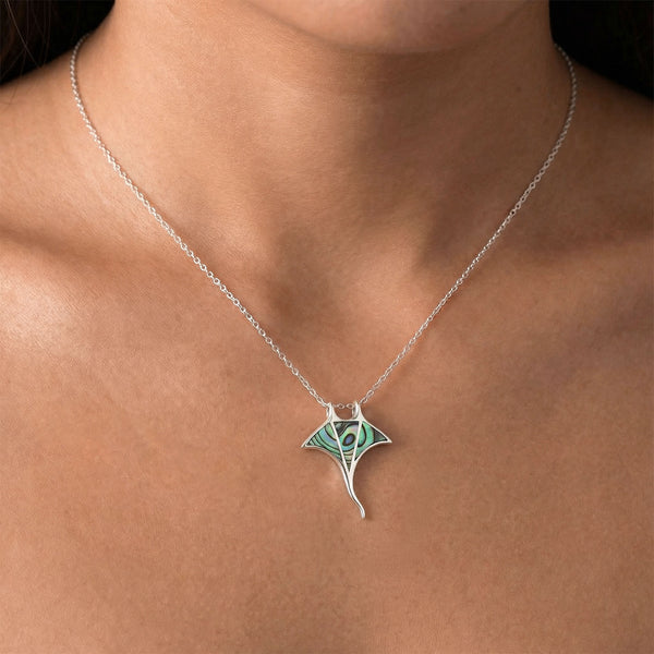 Necklace with a green pendant on a person's neck