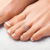 Silver toe ring on a foot with a soft background